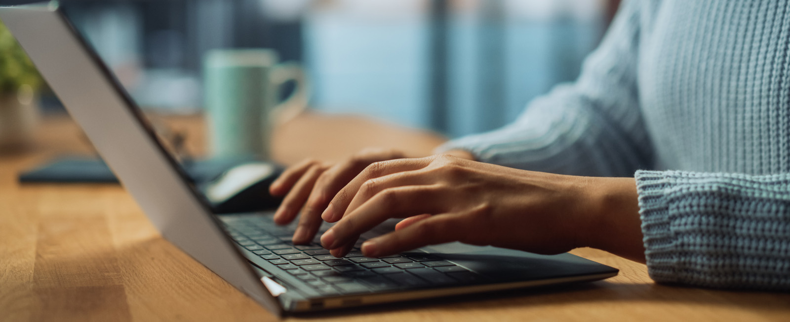 Hands typing on a laptop keyboard. Hands typing on a laptop keyboard.